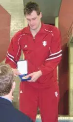 Aaron Opell receives his gold medal from head coach Ray Looze after winning the Big Ten title in the 200 breaststroke.