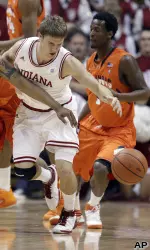 Indiana guard Jordan Hulls, right, and Illinois guard Demetri McCamey reach for a loose ball.