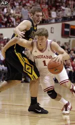 Indiana guard Jordan Hulls, right, drives on Iowa forward Eric May in the second half. (AP Photo/Michael Conroy)