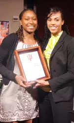 Whitney Lindsay presents Jori Davis with the Whitney Thomas Character Award at Monday night's banquet.