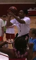 Assistant Coach Amaka Agugua instructs campers on shooting techniques.