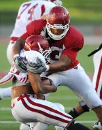 Defensive end Fred Jones makes a stop during Thursday evening's practice.