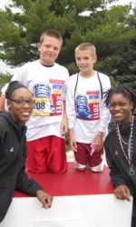 Georgie Jones and Necole Sterling with some young participants at Hoosiers Outrun Cancer race on Sept. 24.