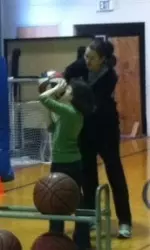 Linda Rubene helps a young Hoosier with her jump shot during the team's visit to the Boys and Girls Club on Martin Luther King, Jr. Day.