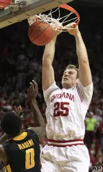 Tom Pritchard dunks against Iowa's Gabriel Olaseni.