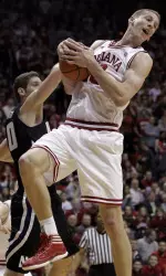 Cody Zeller grabs a rebound over Northwestern forward Davide Curletti.