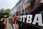 Running back Stephen Houston adds his signature to the BTN's bus.