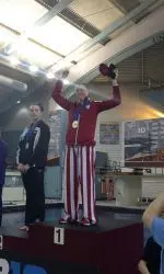 Amy Cozad celebrates her record-setting performance on the platform Saturday night.