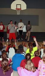Will Sheehey talks with a group of students at Arlington Elementary after the team presented a skit on anti-bullying.