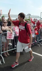 Scott Donley high fives an IU fan before hopping on the bus