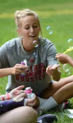 Corinne Karch plays with bubbles at Camp Riley.