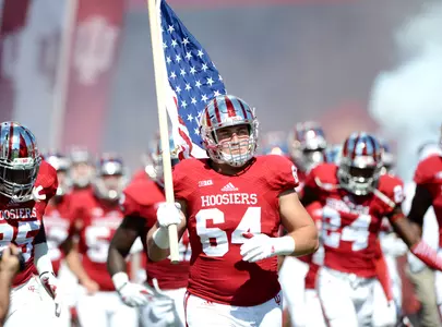 Collin Rahrig (64), players entering the field