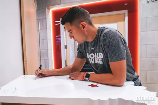 Nick Zeisloft signs Alumni Wall