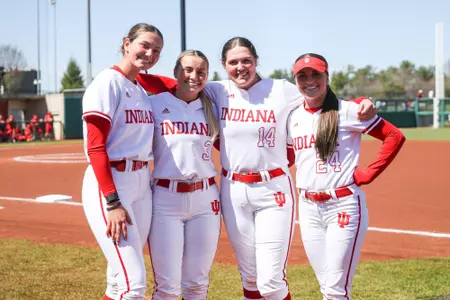 BLOOMINGTON, IN - April 02, 2023 - infield\utility player Sarah Stone #14 and outfielder Taylor Minnick #3 and outfielder Kinsey Mitchell #24 and pitcher\infield Heather Johnson #17 of the Indiana Hoosiers during the game between the Ohio State Buckeyes and the Indiana Hoosiers at Andy Mohr Field in Bloomington, IN. Photo By Dalton Wainscott/Indiana Athletics