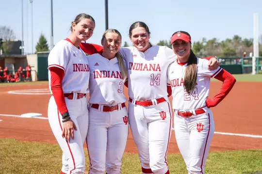BLOOMINGTON, IN - April 02, 2023 - infield\utility player Sarah Stone #14 and outfielder Taylor Minnick #3 and outfielder Kinsey Mitchell #24 and pitcher\infield Heather Johnson #17 of the Indiana Hoosiers during the game between the Ohio State Buckeyes and the Indiana Hoosiers at Andy Mohr Field in Bloomington, IN. Photo By Dalton Wainscott/Indiana Athletics