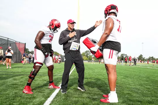 Indiana offensive line coach Bob Bostad running a drill at fall camp.