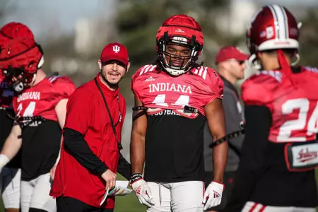 BLOOMINGTON, IN - April 13, 2023 - Indiana Hoosiers Co-Defensive Coordinator and Safeties Coach Matt Guerrieri, linebacker Aaron Casey #44 of the Indiana Hoosiers during practice at Memorial Stadium in Bloomington, IN. Photo By Rachel Gillam/Indiana Athletics