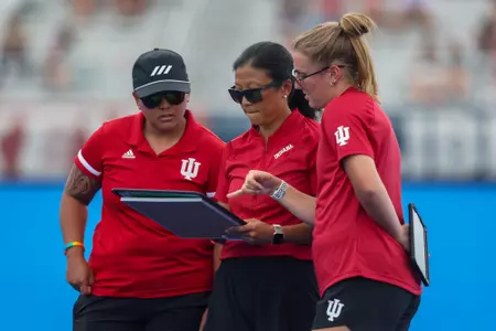 LYNCHBURG, VA - August 27, 2023 - Head Coach Kayla Bashore, Dani Castro, and Leah Zellner of the Indiana Hoosiers during the match agains the Liberty Eagles at Liberty Field Hockey Field in Lynchburg, VA. Photo By Sammy Nance/Indiana Athletics