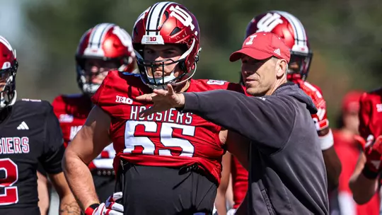 BLOOMINGTON, IN - April 6th, 2024 - offensive lineman Carter Smith #65 of the Indiana Hoosiers and Indiana Hoosiers Run Game Coordinator and Offensive Line Coach Bob Bostad during football Spring Ball Day 8 at Memorial Stadium in Bloomington, Indiana. Photo By Trent Barnhart/Indiana Athletics