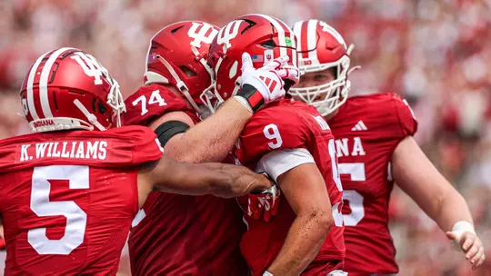 BLOOMINGTON, IN - September 21, 2024 - quarterback Kurtis Rourke #9 of the Indiana Hoosiers and offensive lineman Bray Lynch #74 of the Indiana Hoosiers during the game between the Charlotte 49ers and the Indiana Hoosiers at Memorial Stadium in Bloomington, Indiana. Photo By Trent Barnhart/Indiana Athletics