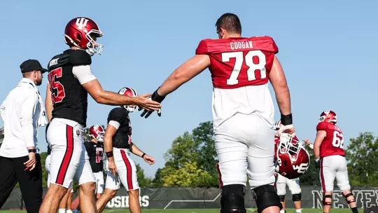 BLOOMINGTON, IN - August 07, 2025 - quarterback Fernando Mendoza #15 of the Indiana Hoosiers and offensive lineman Pat Coogan #78 of the Indiana Hoosiers during Fall Camp at John Mellencamp Pavillion in Bloomington, IN. Photo By Grace Urbanski/Indiana Athletics