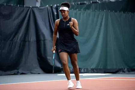 Hi’ilani Williams celebrates after a hard-fought point on the court during a tennis match.