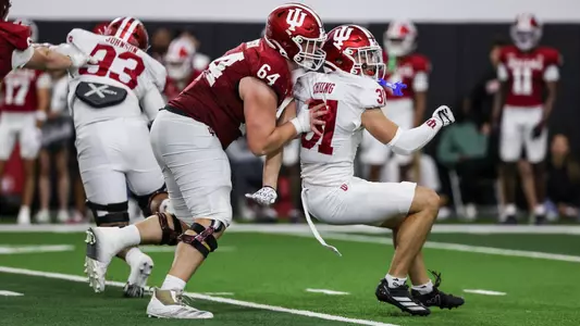 BLOOMINGTON, IN - April 18, 2026 - offensive lineman Chance Johnson #64 of the Indiana Hoosiers and defensive back Anthony Chung #31 of the Indiana Hoosiers during practice at Mellencamp Pavilion in Bloomington, IN. Photo By Dani Meersman/Indiana Athletics