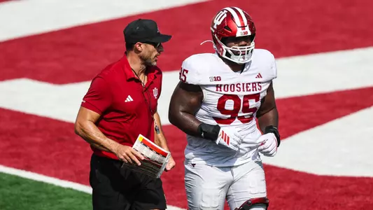 BLOOMINGTON, IN - August 13, 2026 - Indiana Hoosiers Defensive Tackles Coach Pat Kuntz and defensive lineman Tyrique Tucker #95 of the Indiana Hoosiers during practice at Merchants Bank Field at Memorial Stadium in Bloomington, IN. Photo By Dani Meersman/Indiana Athletics