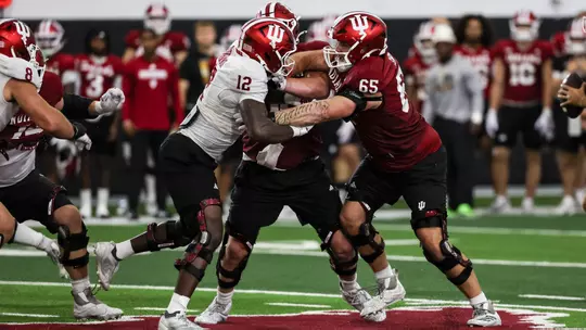 BLOOMINGTON, IN - August 19, 2026 - defensive lineman Tobi Osunsanmi #12 of the Indiana Hoosiers and offensive lineman Carter Smith #65 of the Indiana Hoosiers during practice at Mellencamp Pavilion in Bloomington, IN. Photo By Dani Meersman/Indiana Athletics