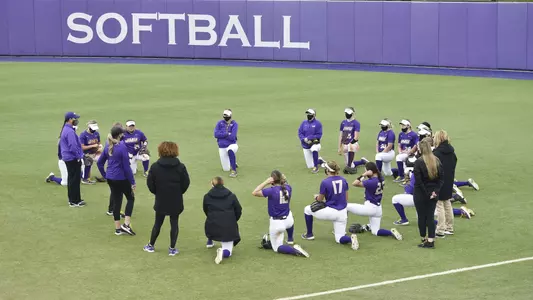 Team in circle kneeling