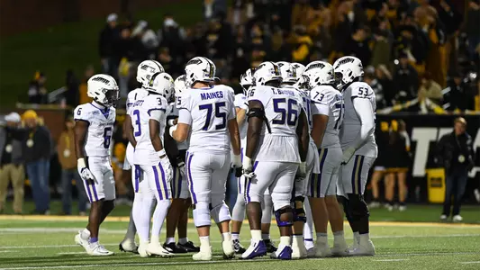 JMU's offense huddles during a game at App State on Oct. 22.