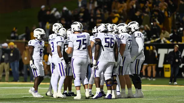 JMU's offense huddles during a game at App State on Oct. 22.