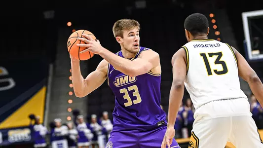 James Madison forward Gabe Newhof looks to make a pass against Southern Miss.