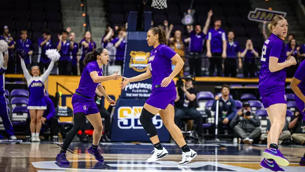 Bree Robinson and Peyton McDaniel celebrate on the court after play against Troy in Sun Belt title game.