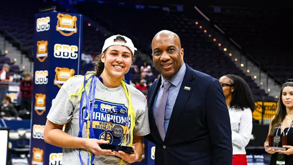 Peyton McDaniel accepts the Sun Belt Conference's Most Outstanding Player Award from Commissioner Keith Gill after defeating Troy in the Sun Belt title game.