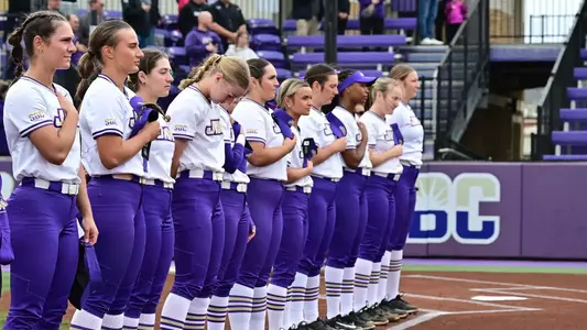 JMU softball during the national anthem at a home game at Veterans Memorial Park in 2026.