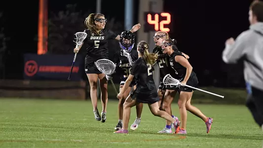 JMU celebrates a goal in its comeback victory at #19 Virginia on March 25.