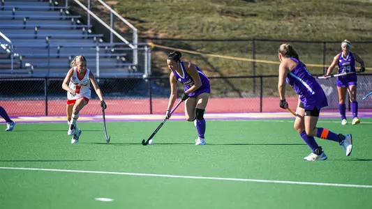 Mika Hilburger working the ball upfield against Ball State at the JMU Field Hockey Complex