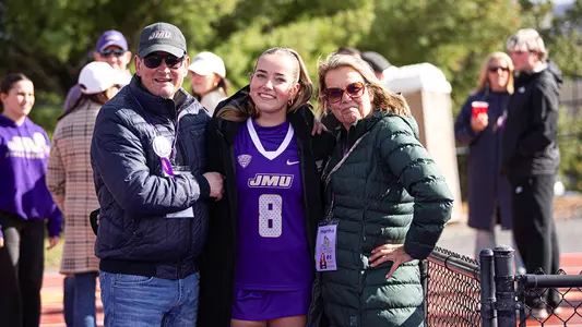Alice Roeper posing with her parents during Senior Ceremony at the JMU Field Hockey Complex
