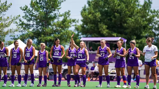 Julie Narleski waving to the crowd during the starting lineup PA read before a scrimmage against the DC Dragons at the JMU Field Hockey Complex