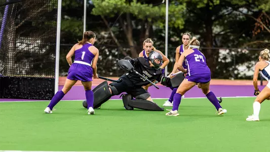 Lilly Sweeney dives to her left for a save against Longwood at the JMU Field Hockey Complex