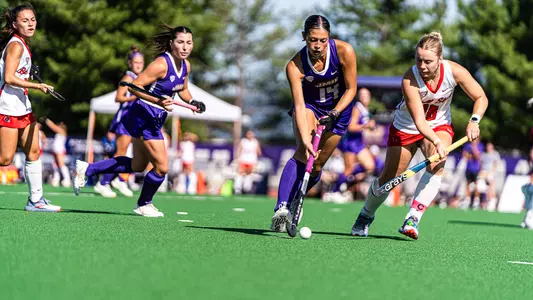 Sydney Raguini dribbling the ball upfield versus Ball State at the JMU Field Hockey Complex