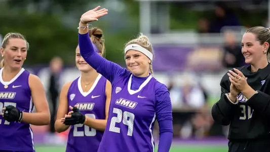 Jola Ollrogge waving to the crowd during the starting lineup read before playing Miami (Ohio) at the JMU Field Hockey Complex