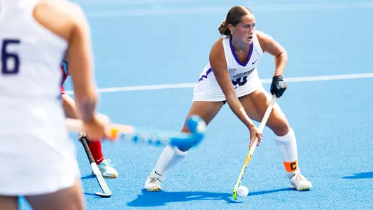 Skyler Brown scans with the ball scanning the field against Liberty at the Liberty Field Hockey Field