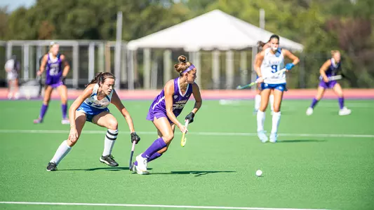 Skyler Brown scans upfield with the ball at her feet against Duke at the JMU Field Hockey Complex