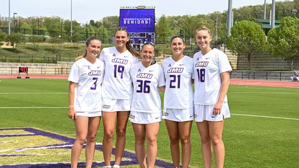The 2026 JMU Lacrosse Seniors pose for a photo ahead of their game against Vanderbilt.