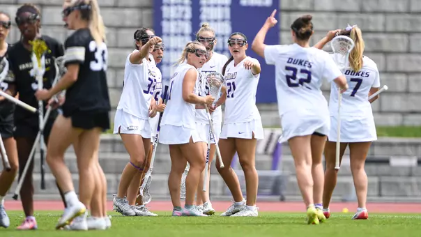 JMU Lacrosse huddles during its game against Vanderbilt.
