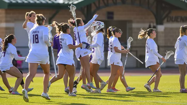 JMU Lacrosse celebrates after defeating Georgetown