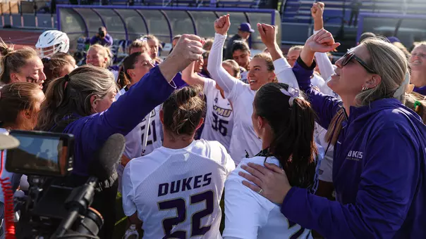JMU Lacrosse huddles ahead of their game against Georgetown
