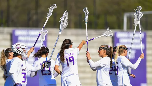 JMU Lacrosse huddles during their game against Georgetown